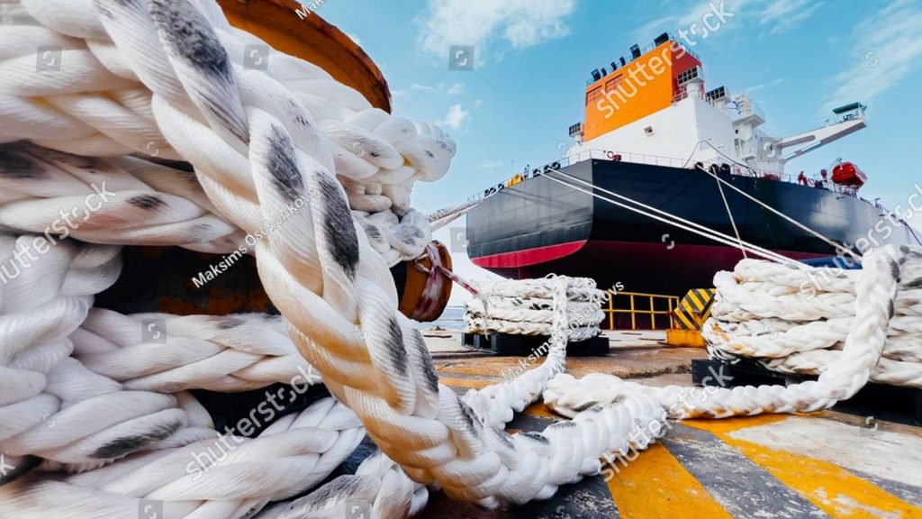 stock photo thick mooring ropes in foreground with large oil tanker ship docked at port 2772900989